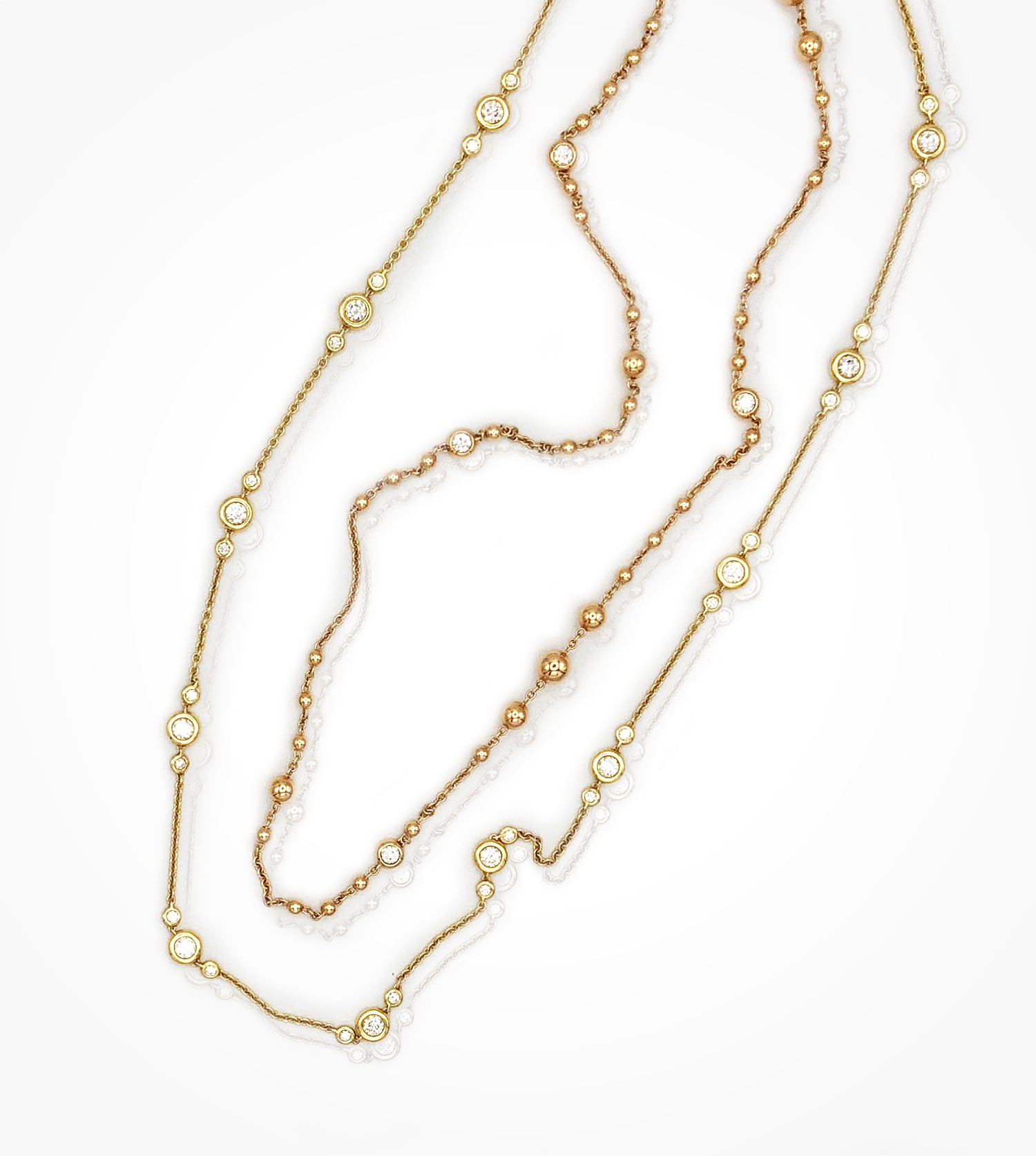 NE08268-18KY bezel set 66 diamond 36in-long station chain necklace. --NE08285-18KP spaced beads and diamond=0.80cts, 34in long necklace SOLD